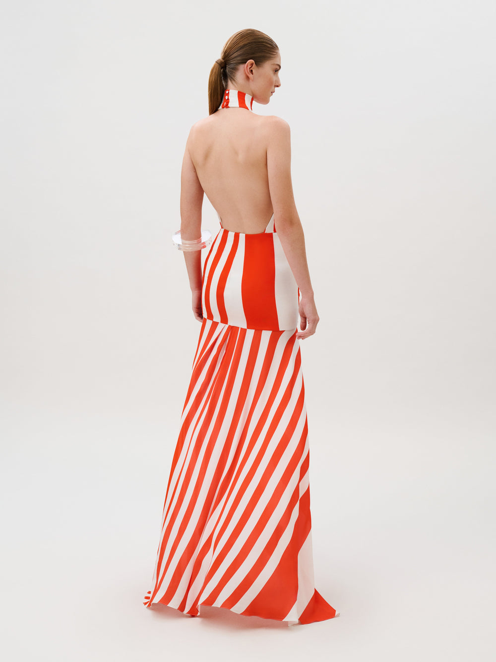 Belona Dress: a backless maxi dress in red and white vertical stripes, crafted from Italian fabric with a halter neck.