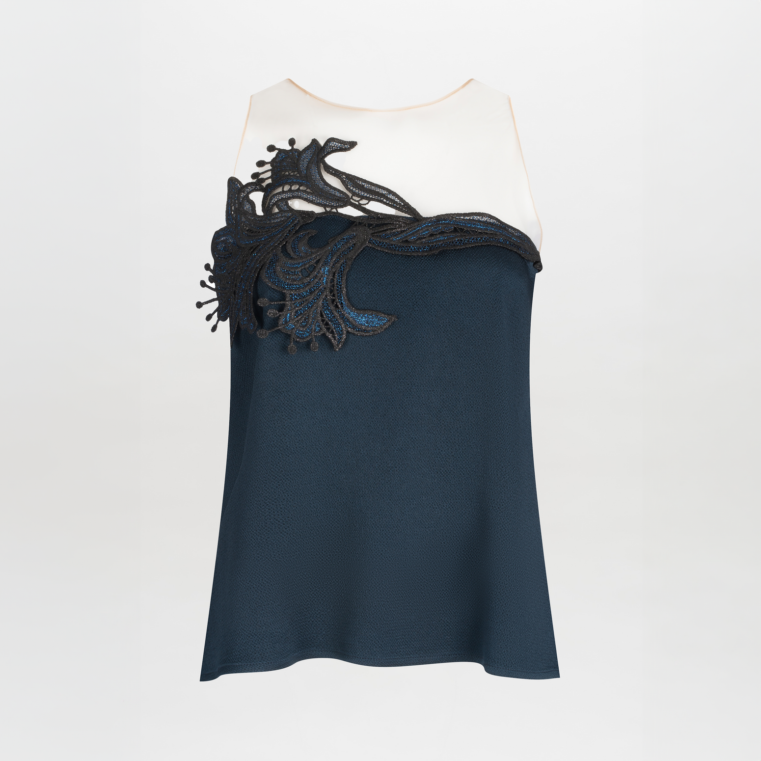 A Brisa Blouse Navy with a white upper and dark blue lower section, featuring intricate guipure lace detailing on the chest.