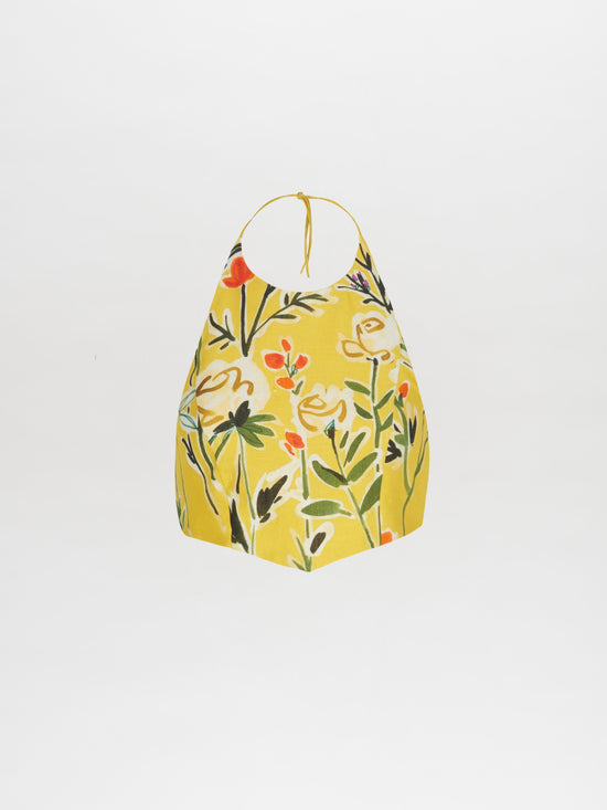 A Bruna Top Golden Wallflowers with a vibrant floral pattern in yellow, orange, and green on a white background features a cropped silhouette.