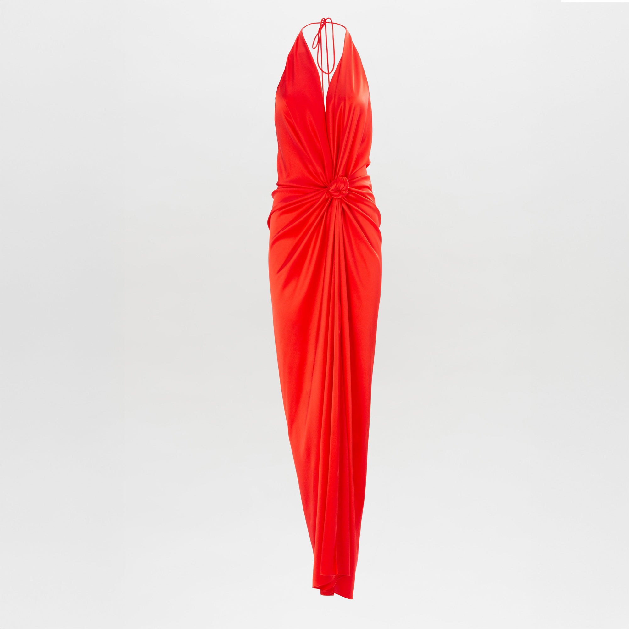 The Jazmin Dress is a sleeveless, floor-length red halter dress featuring a deep V-neckline and gathered fabric at the waist, shown against a plain white background.