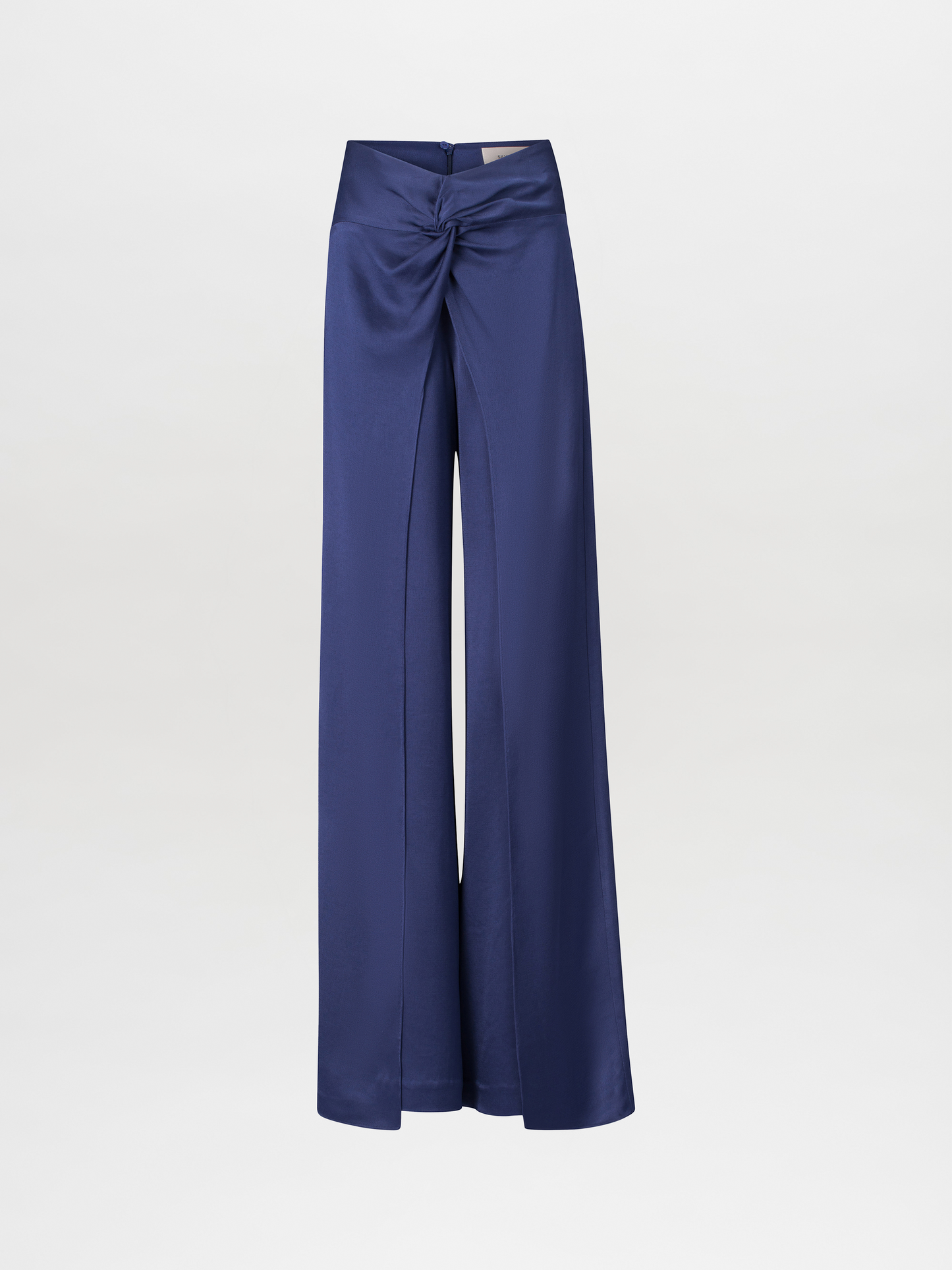 The Canturipe Pant Navy is a pair of high-waisted satin pants that feature a twisted knot detail at the front, showcasing a wide-leg silhouette with draped fabric and an elegant design. They come with a concealed zipper closure.