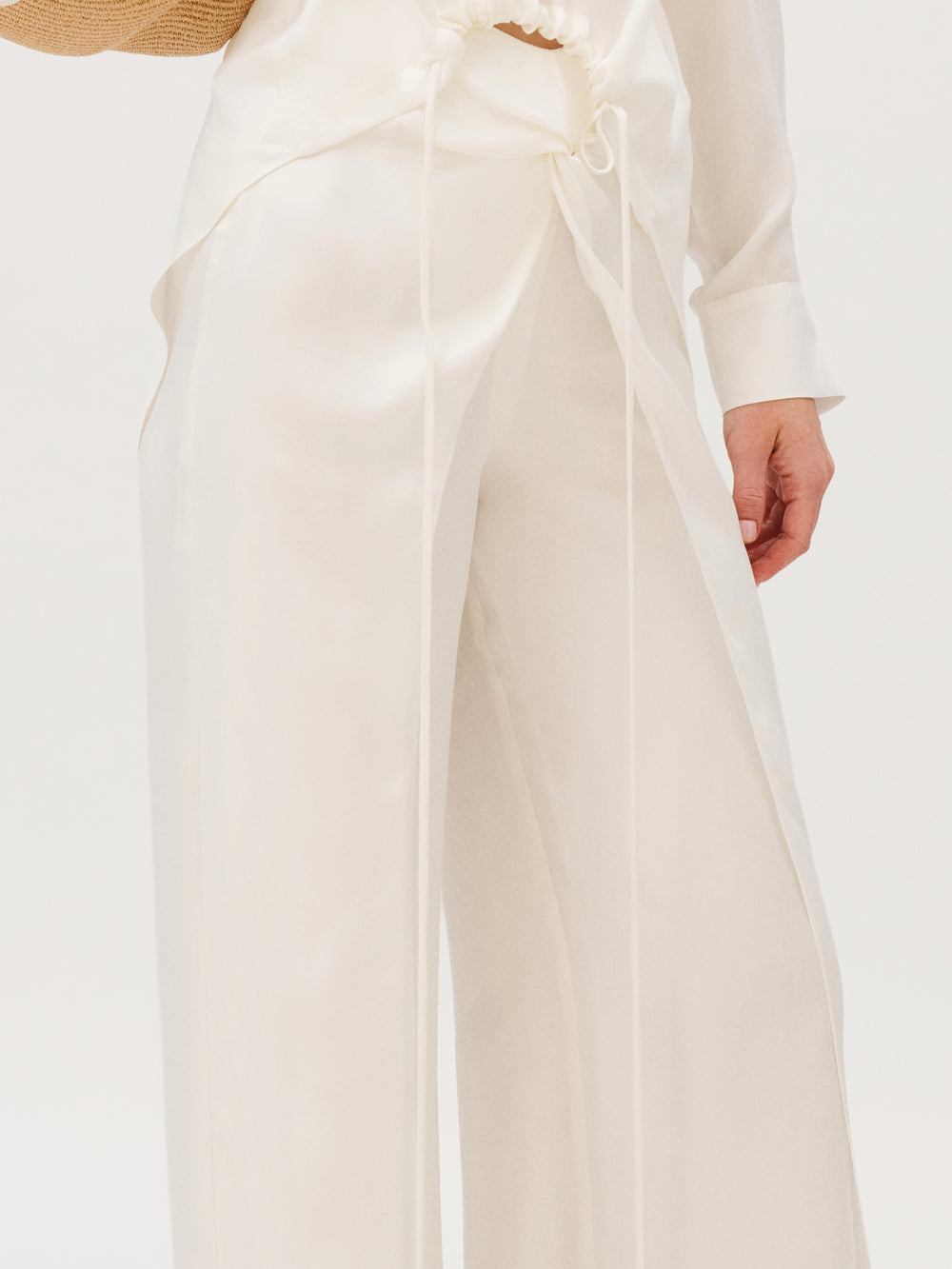 Canturipe Pant in cream-colored cupro, featuring a wide-leg cut, high-waisted wrap detail, and long front ties.