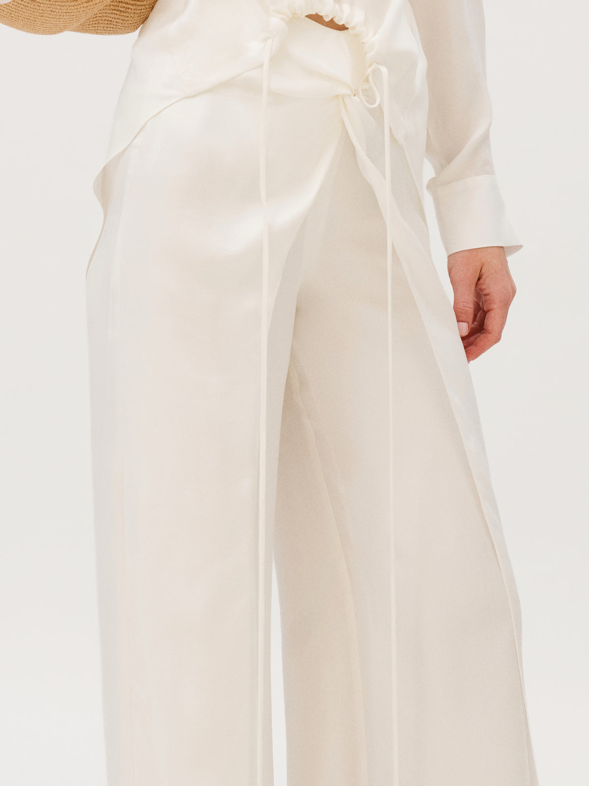 Canturipe Pant in cream-colored cupro, featuring a wide-leg cut, high-waisted wrap detail, and long front ties.