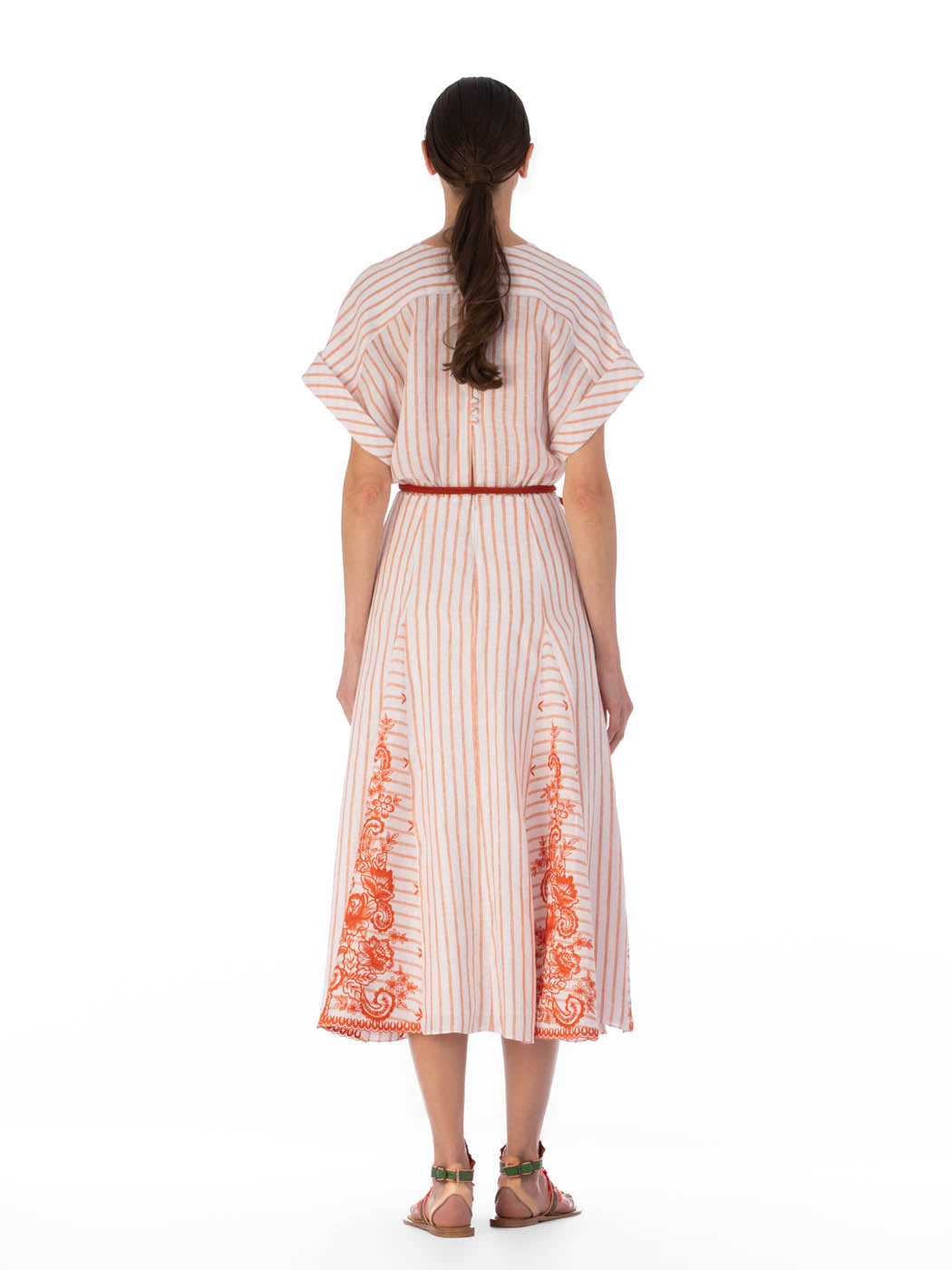 Casandra Dress Coral Paisleys Stripes with short sleeves and a v-neckline, accented by a red drawstring waist and ornate patterns along the hem.