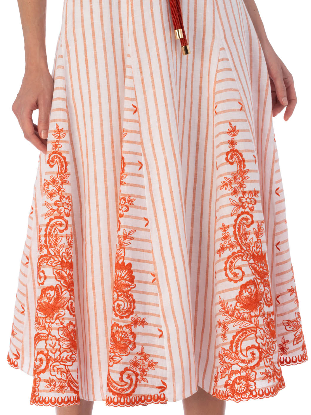 Casandra Dress Coral Paisleys Stripes with short sleeves and a v-neckline, accented by a red drawstring waist and ornate patterns along the hem.