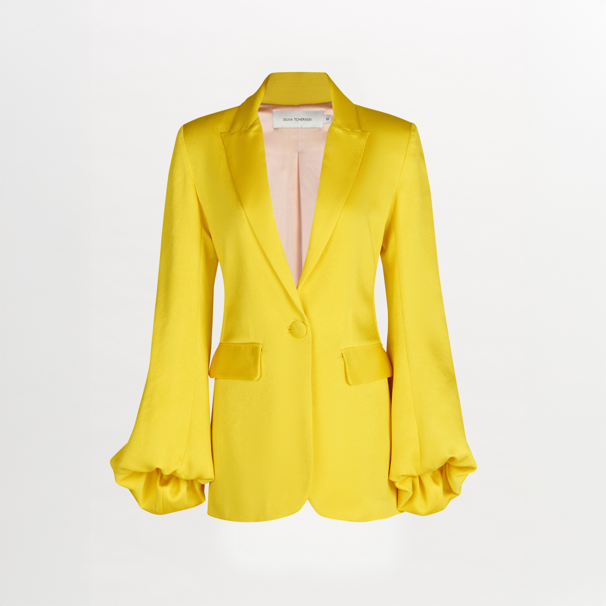 A Coco Blazer Yellow with satin ruffled sleeves.