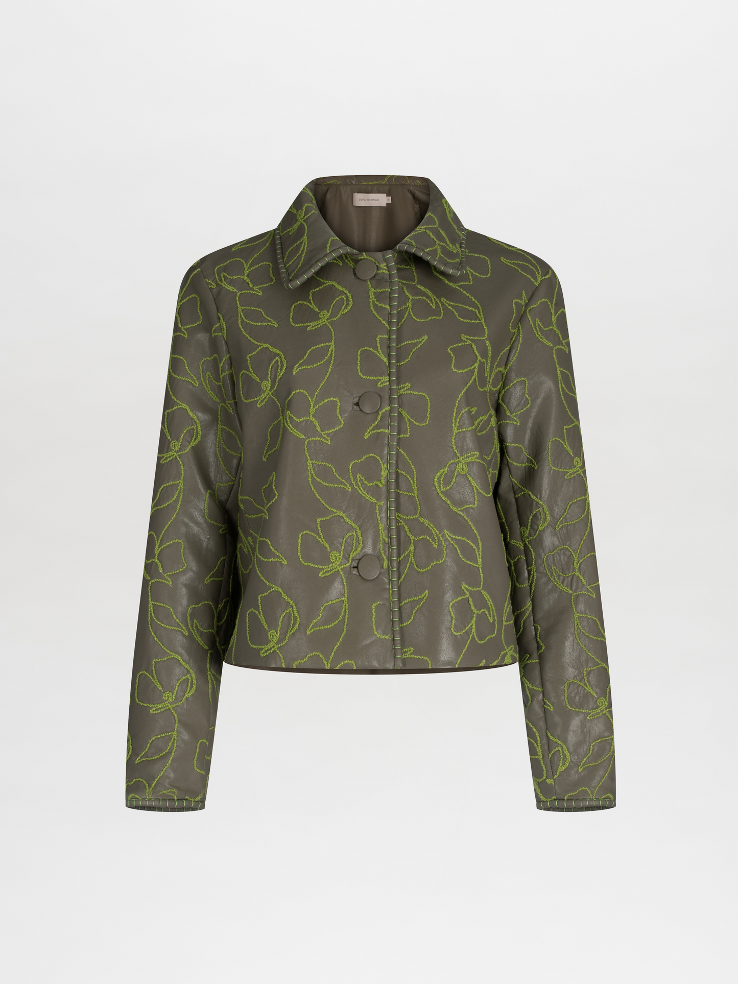 Explore the Columba Jacket in Forest Green, crafted from embroidered ecoleather. It showcases lime green floral embroidery, a chic collar, a button-down front, and long sleeves for an elegant mix of classic style with striking embroidery.