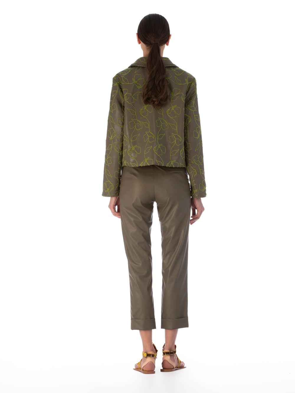 Explore the Columba Jacket in Forest Green, crafted from embroidered ecoleather. It showcases lime green floral embroidery, a chic collar, a button-down front, and long sleeves for an elegant mix of classic style with striking embroidery.