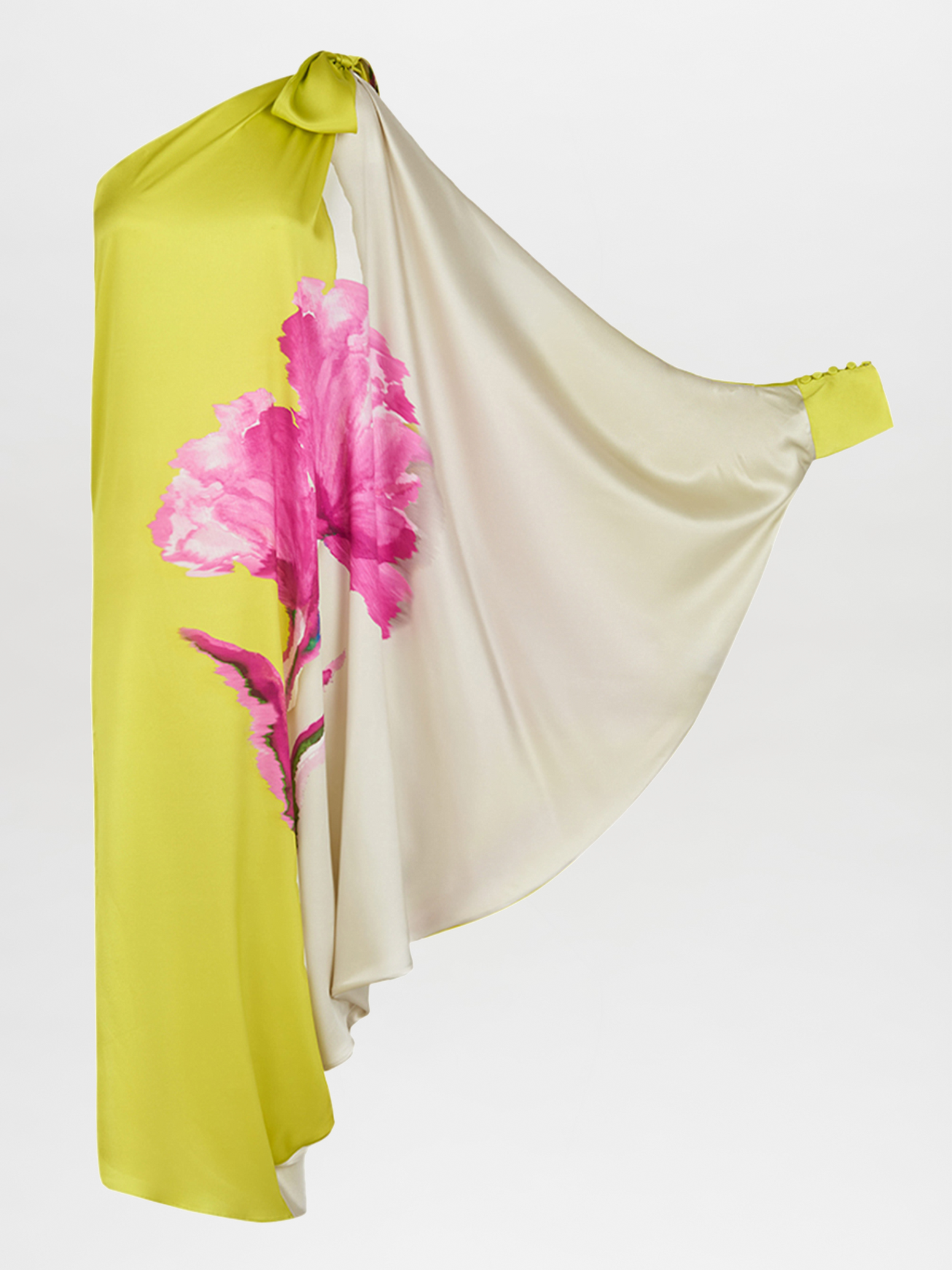 The Crema Tunic Chartreuse Beige Floral is a one-shoulder, asymmetrical silk tunic adorned with large pink floral prints and featuring a draped sleeve.