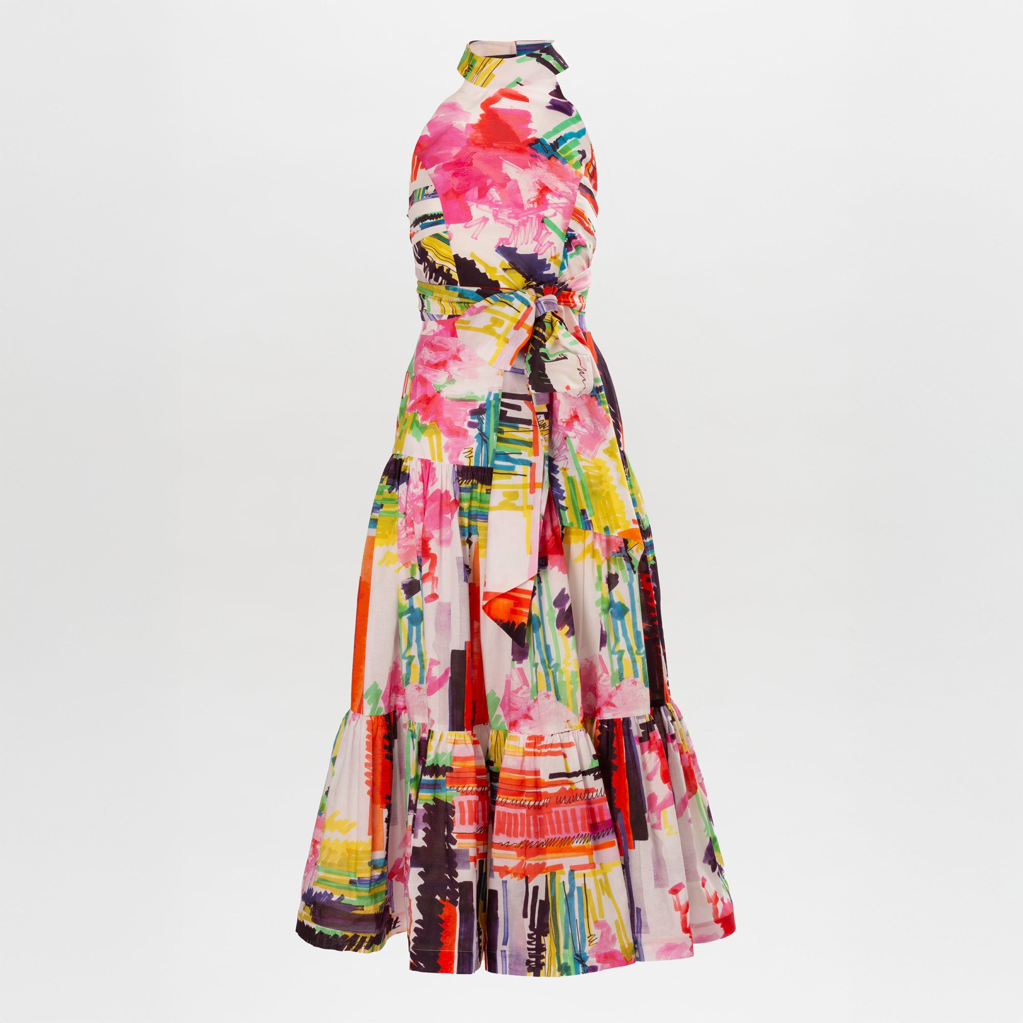 The Dilara Dress Set is a sleeveless, high-neck, floor-length dress featuring a colorful abstract floral print and a waist tie, shown against a plain white background.