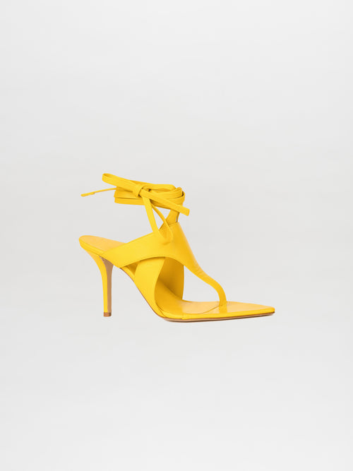 The Domenico Heels Limoncello by GIA Couture are crafted in exquisite Italian leather, showcasing a vibrant yellow color with a thin strap and elegant ankle tie, all beautifully presented against a plain white background.