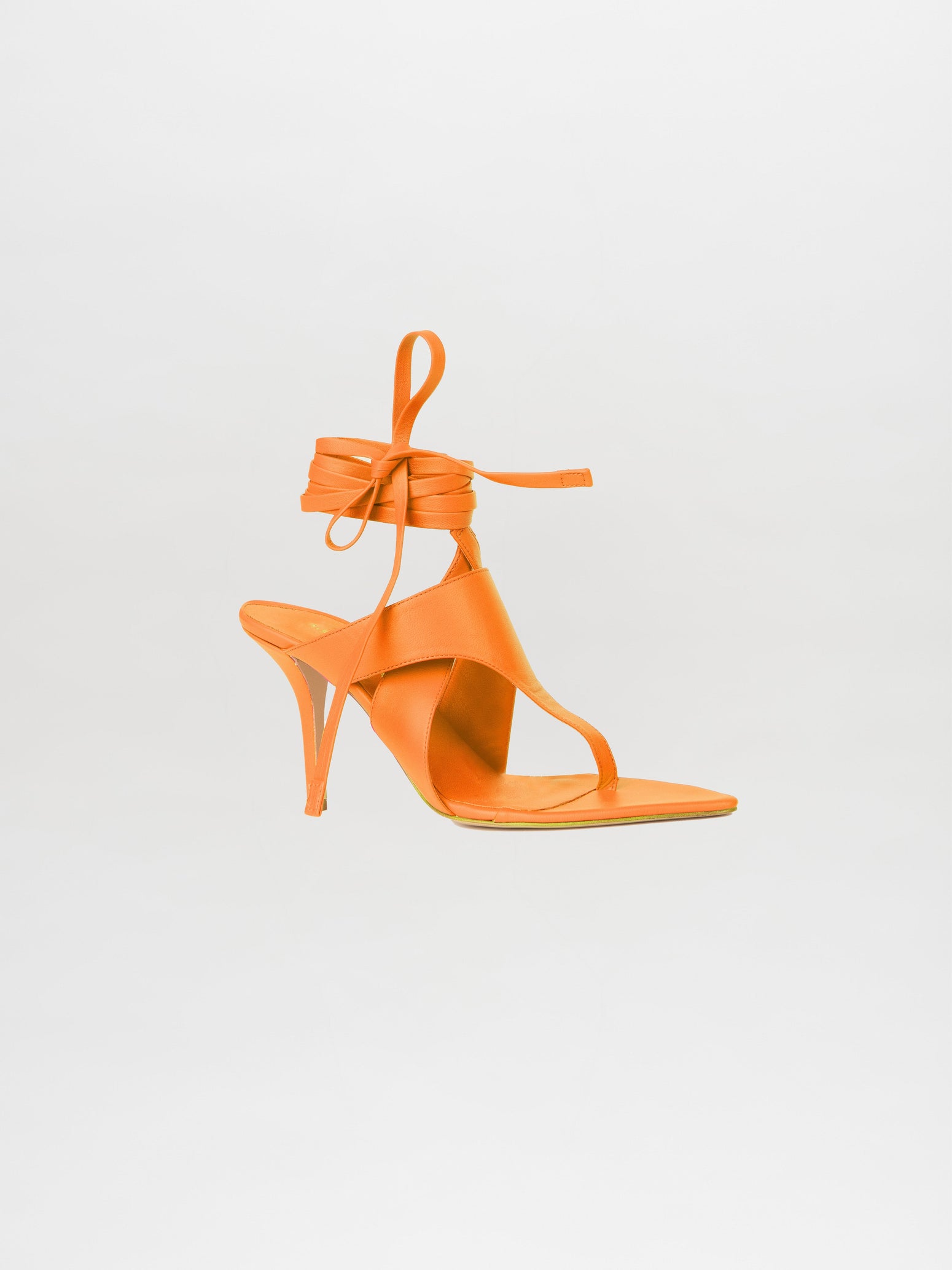 The Domenico Heels Orange, crafted from Italian leather and featuring a square toe with a lace-up ankle strap, are elegantly displayed against a plain white backdrop. This chic design is part of the GIA Couture collection, epitomizing the sophistication of high-heeled sandals.