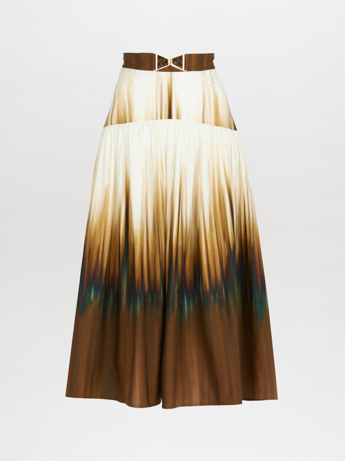 A lightweight cotton ombre Damla skirt with a belt in a Tuscan Sunset print.