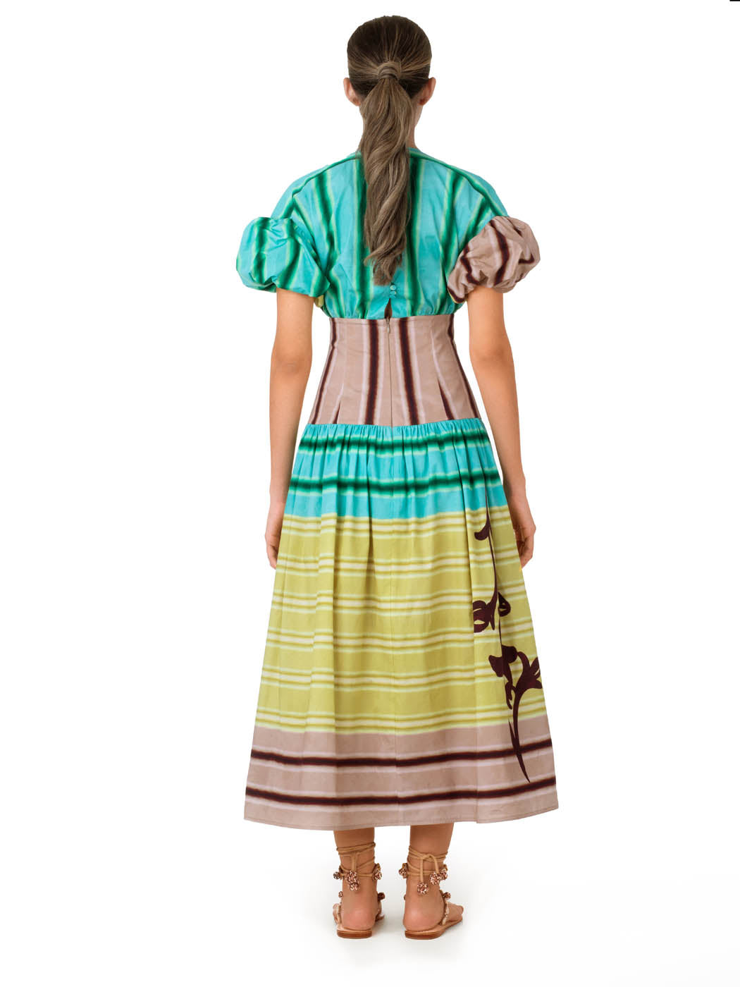 A Darice Dress Meadow View with puffed sleeves and a multicolor stripe pattern in shades of green, pink, and beige, featuring a floral design on the lower part, isolated on a white background.