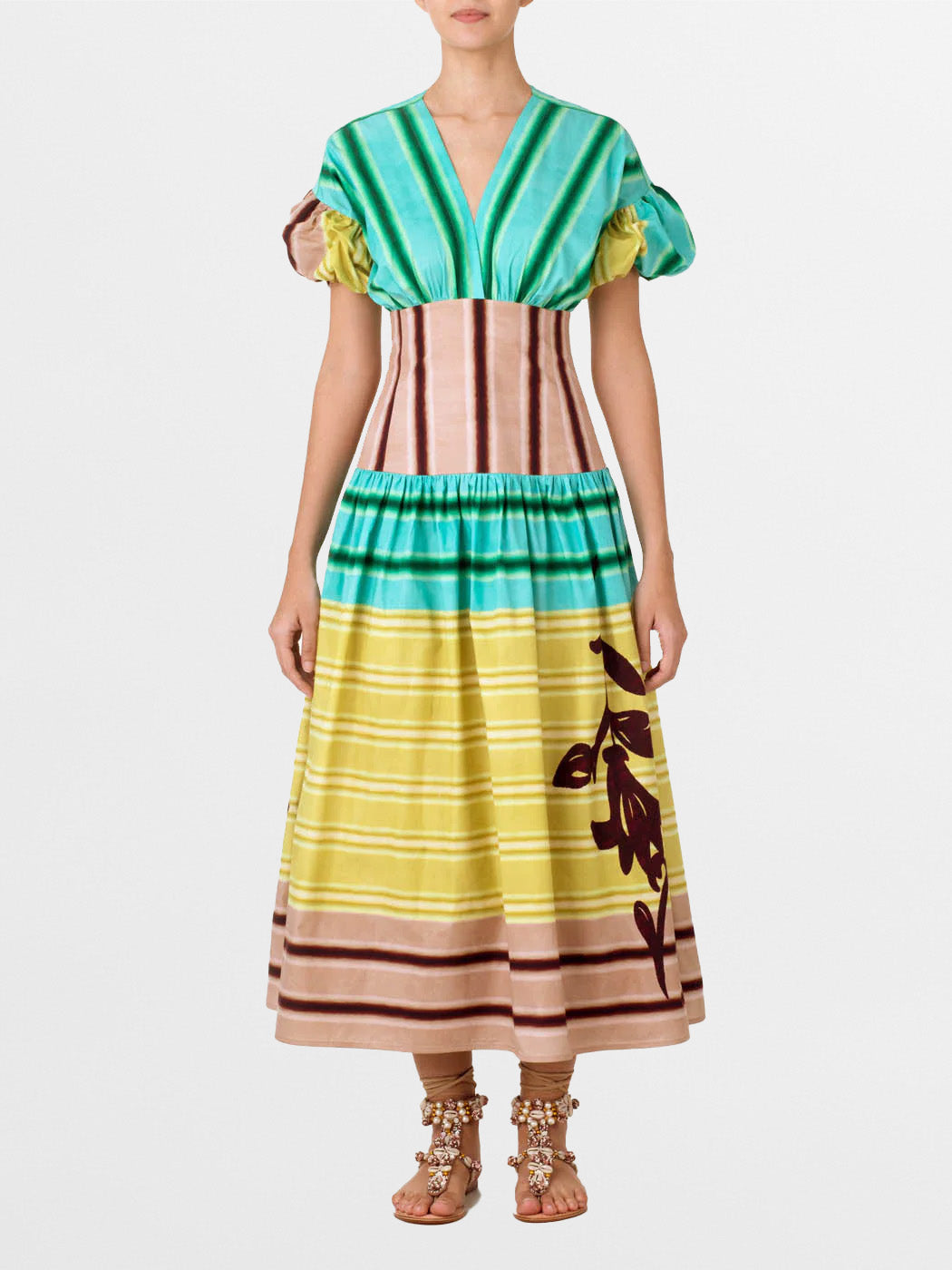 A Darice Dress Meadow View with puffed sleeves and a multicolor stripe pattern in shades of green, pink, and beige, featuring a floral design on the lower part, isolated on a white background.
