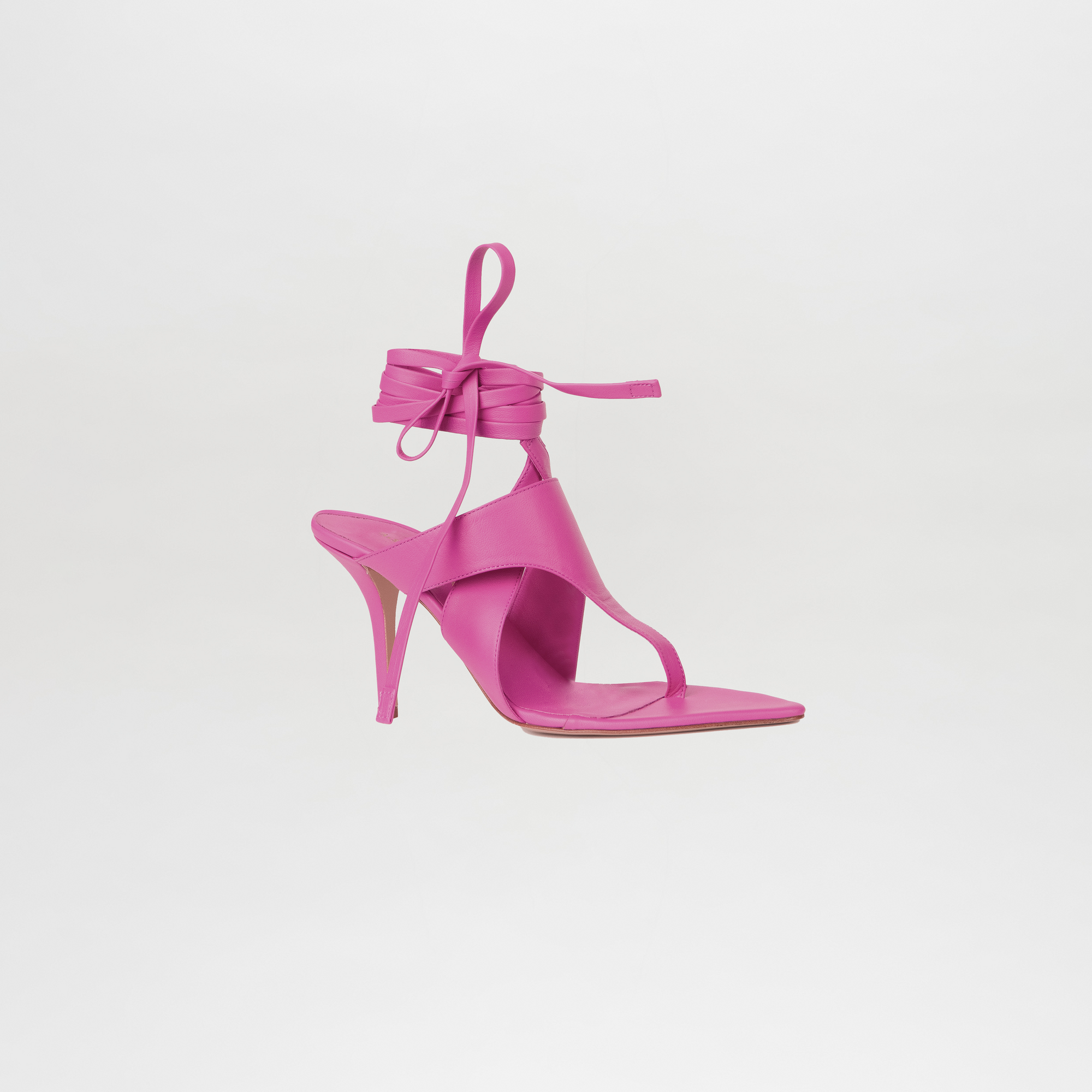 Pink high-heeled sandal with ankle strap on a light gray background