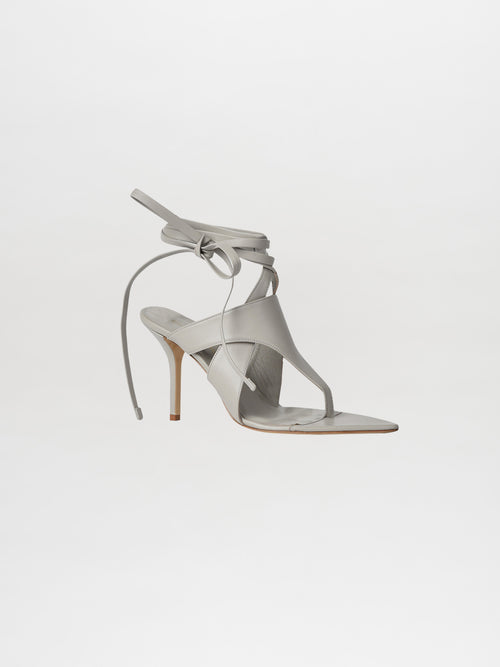 The Domenico Heels Gray by GIA Couture, made from luxurious Italian leather, showcase ankle wrap straps in a light gray color, beautifully set against a white background.