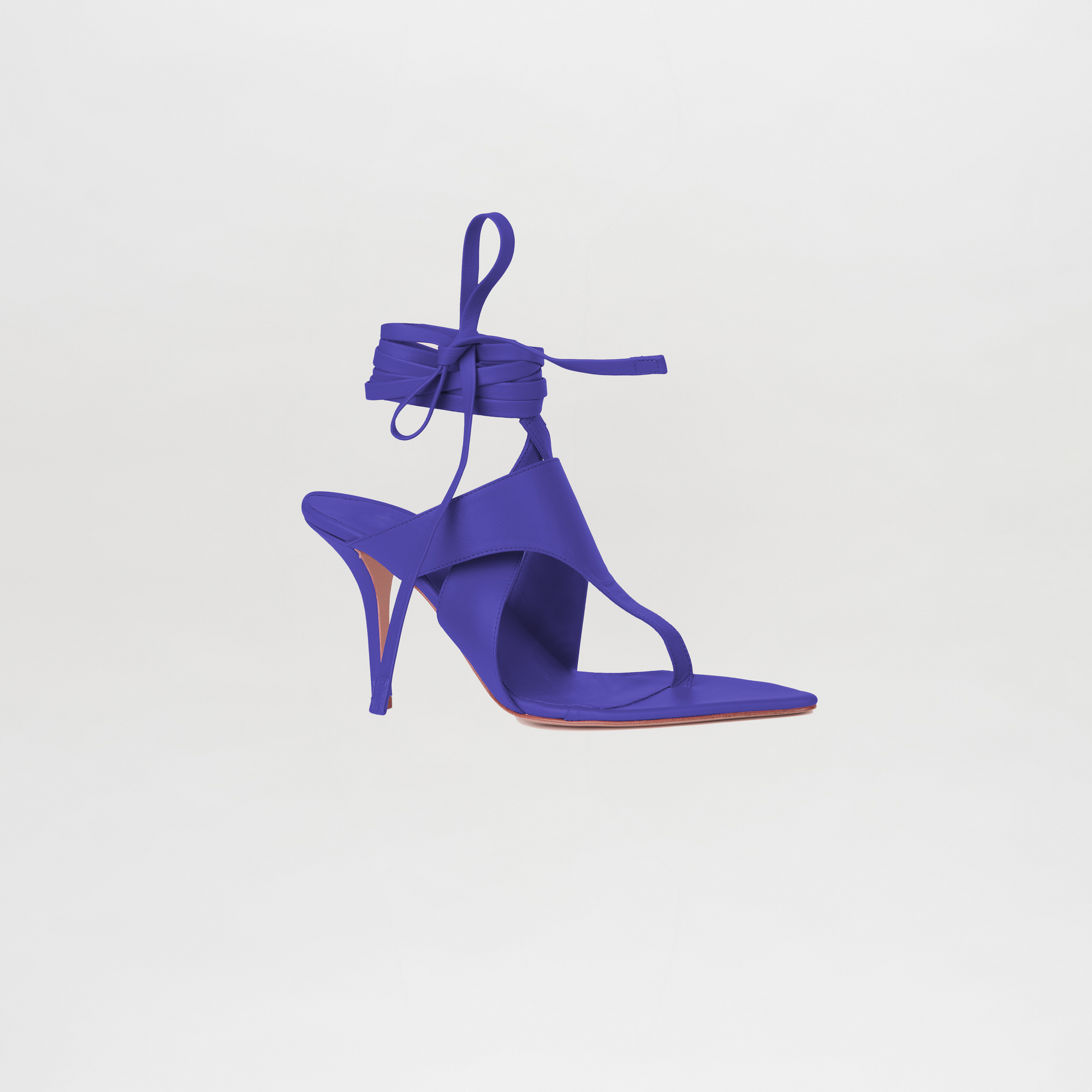 Purple high-heeled sandal on a light gray background