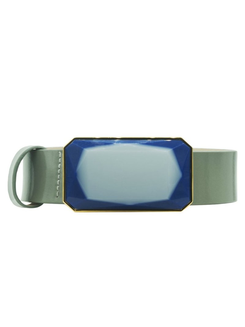 The Dora Belt Steel Blue showcases a large, blue, octagonal buckle with a gold trim, embodying the elegance and precision reminiscent of a well-ordered ship's design.