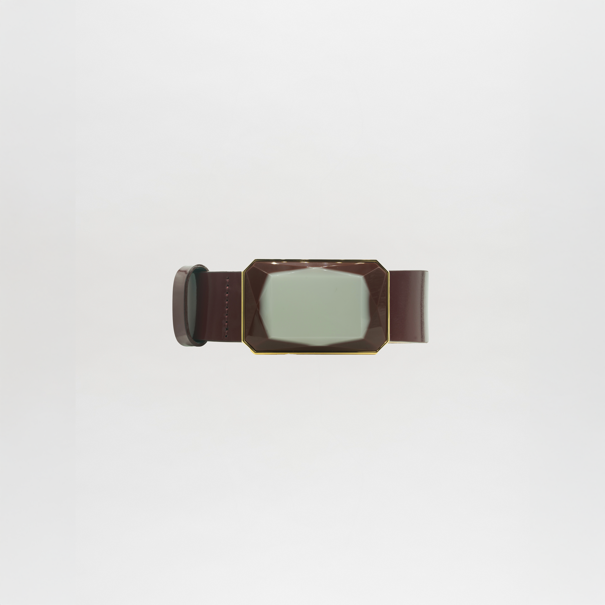 The Dora Belt is a brown belt with a large, rectangular, faceted buckle featuring a pale green center, displayed on a plain white background and ready to ship within days of your order.
