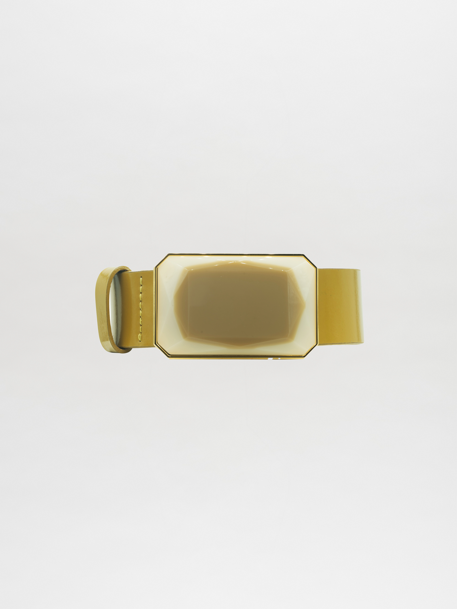 The Dora Belt Ivory, featuring a beige and gold rectangular belt buckle with a glossy surface, is attached to a matching strap and placed against a plain white background, evoking the elegance of bygone days.