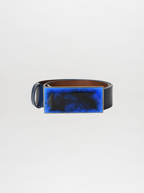 The Dora Belt Navy is a striking leather statement belt featuring a large rectangular buckle adorned with a blue and black marbled design.