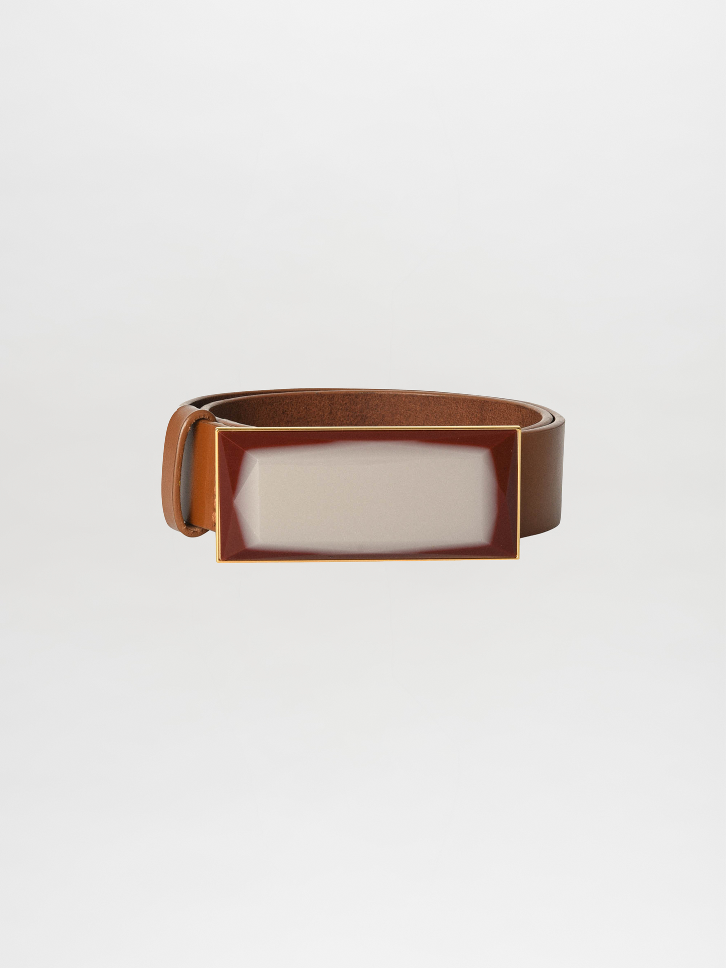 The Dora Belt Pearl by Silvia Tcherassi showcases luxurious camel leather complemented by a sleek rectangular silver buckle, making it a timeless and stylish accessory choice.