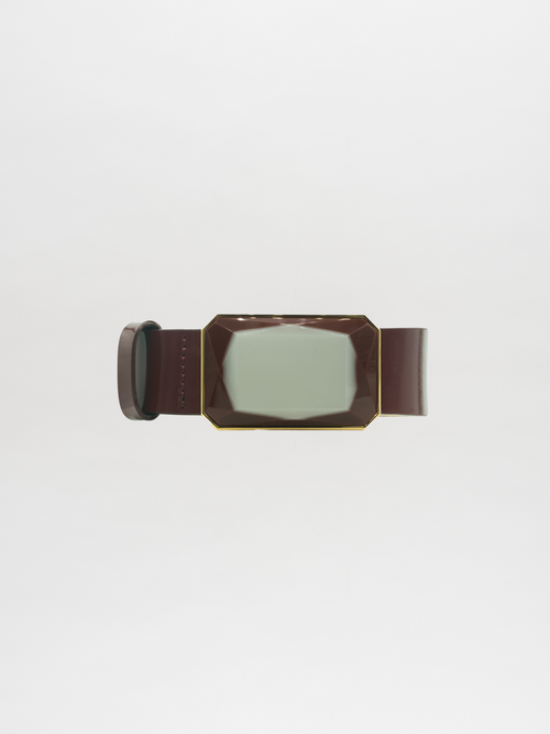 The Dora Belt, featuring a glossy central design and rectangular buckle on a brown leather strap, is ready to order and ship, displayed against a plain white background.