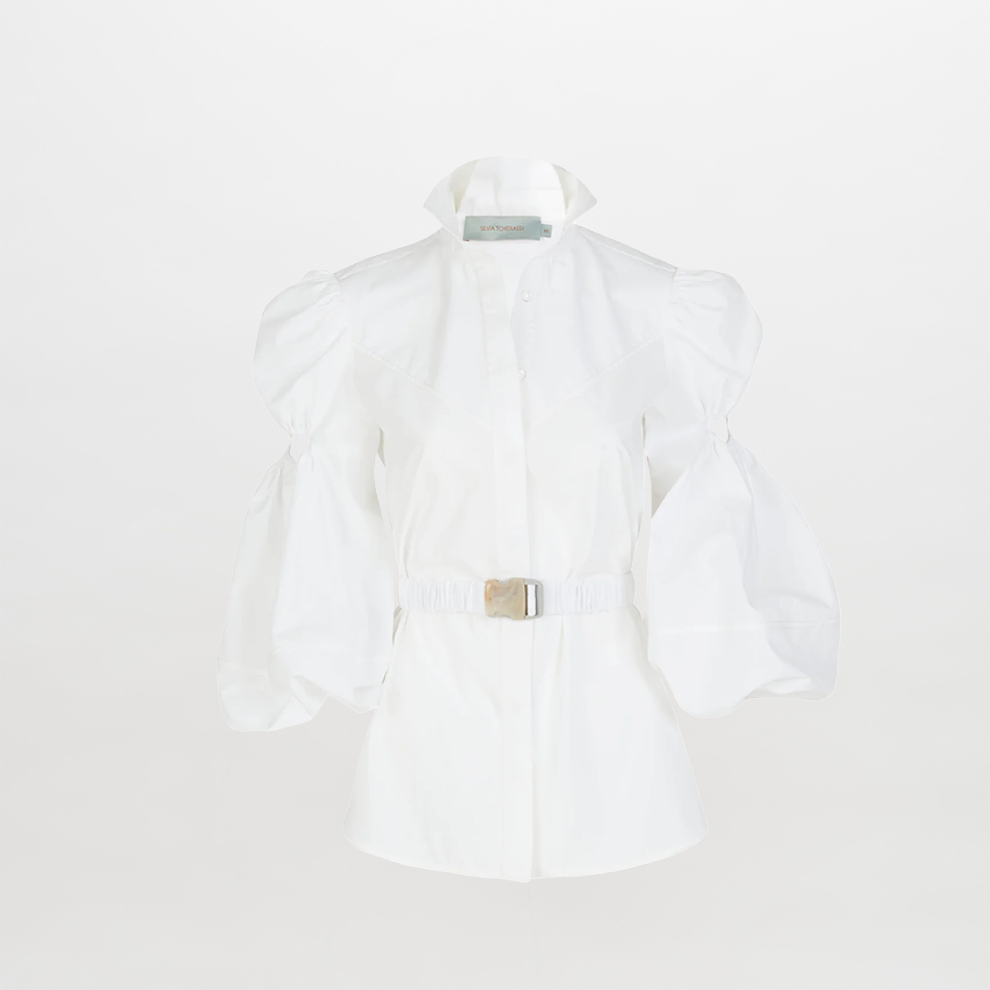 The Enio Blouse White is a long-sleeve shirt dress with puffed sleeves, a high collar, belted waist with a rectangular buckle, and delicate floral embroidery, shown on a plain white background.