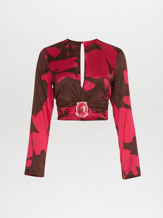 A pink and brown Edith Blouse Fuchsia Cacao with a belt, featuring an Italian resin detail.