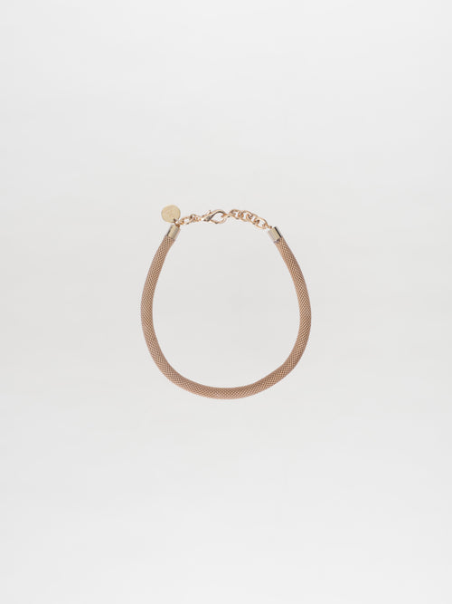 The Elara Necklace Gold in the Tcherassi design showcases a delicate chain with a small circular tag and clasp, beautifully set against a plain white background.