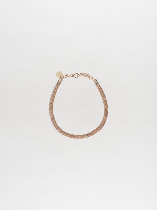 The Elara Necklace Gold in the Tcherassi design showcases a delicate chain with a small circular tag and clasp, beautifully set against a plain white background.