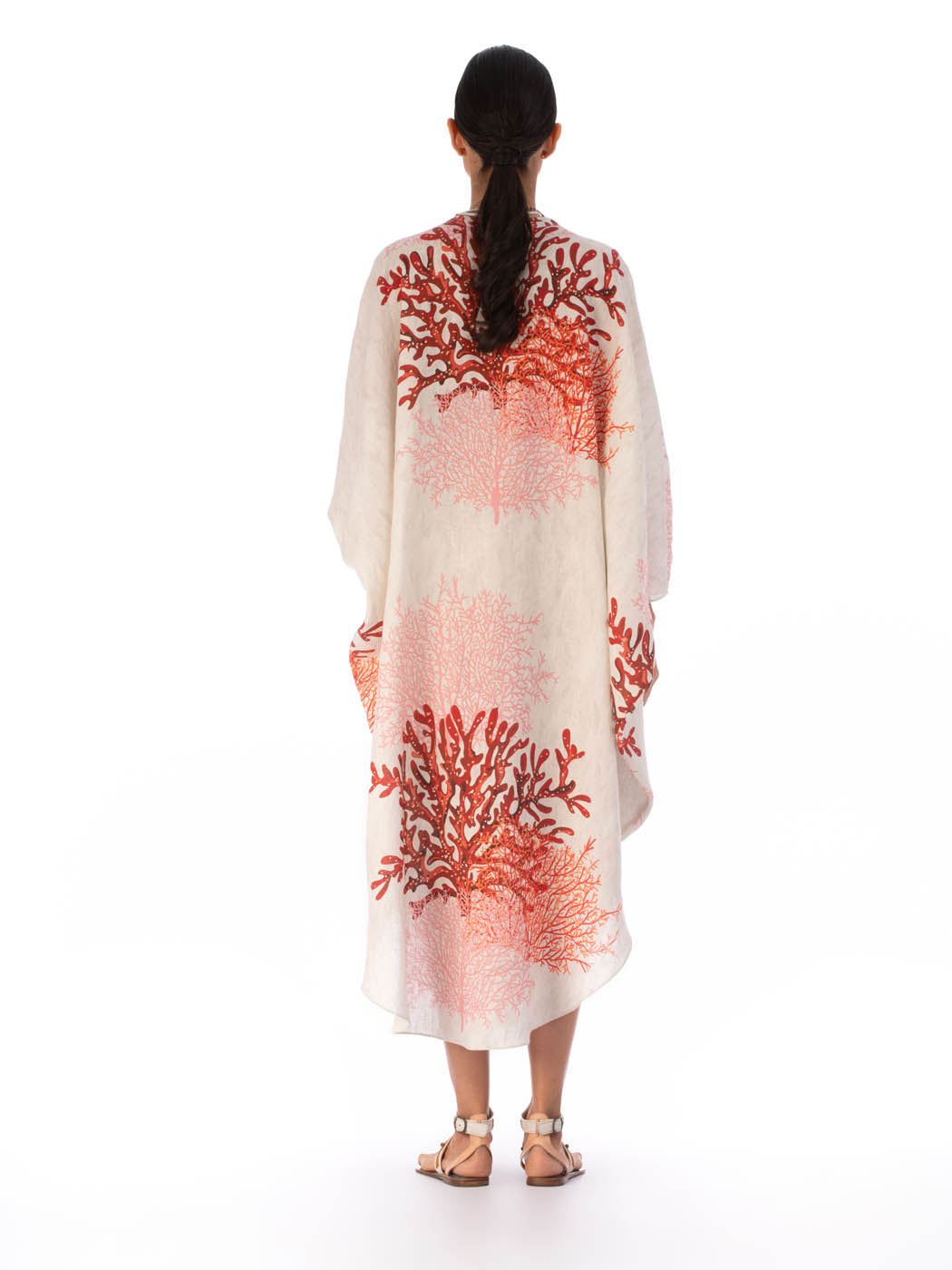 Elea Tunic Multi Coral with red coral pattern, quarter sleeves, and a v-neck, isolated on a white background.