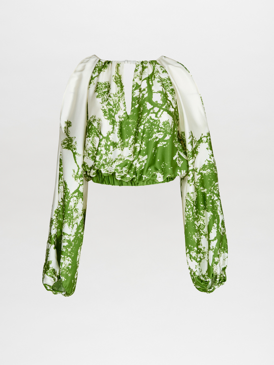 An Elke Blouse Green Cyprus in a nature-inspired print, with an adjustable fit.