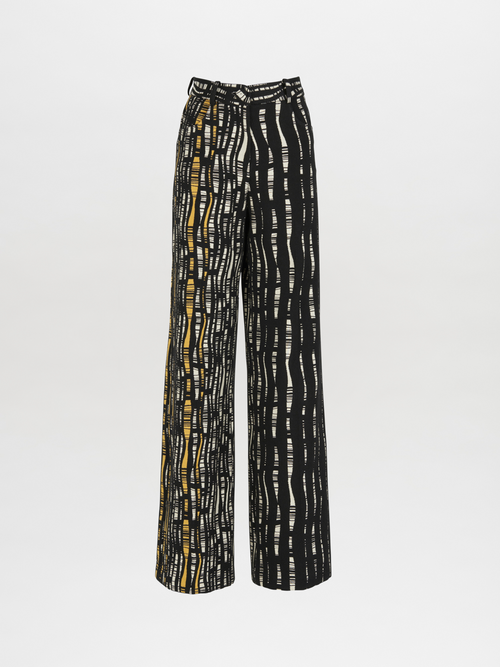 The Emine Pant Black White features a wide-legged cut with vertical black and white stripes and a yellow accent, showcased against a plain white background.