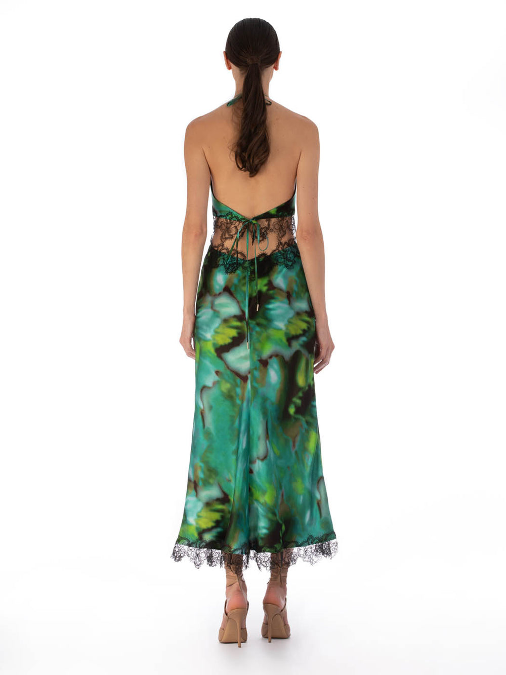 An elegant Eugenia Dress Juniper Green with a vibrant turquoise and green abstract pattern and black lace trim around the neckline and hem.