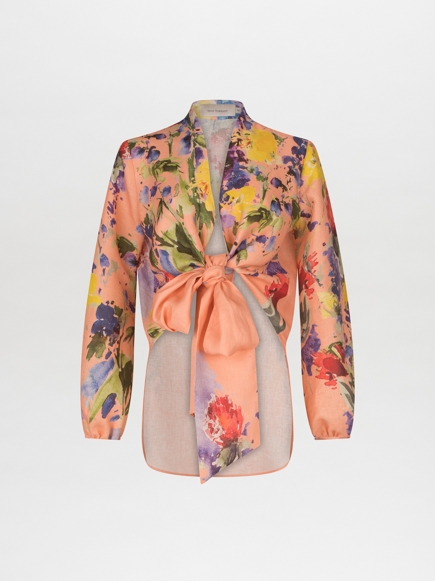 A Floral Blouse Apricot Spring Garden with a bow at the v neckline.