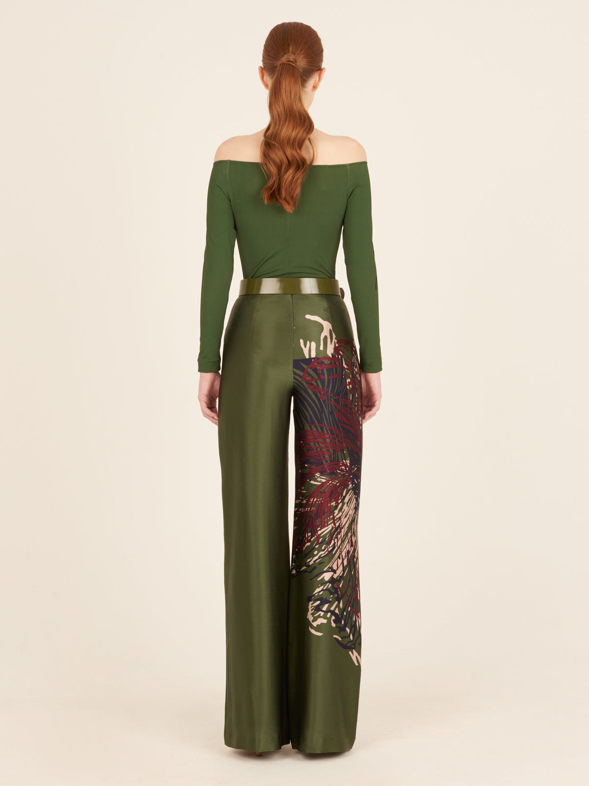 The woman is wearing comfortable green wide leg pants with floral print.
Product Name: Florence Bodysuit Green Floral