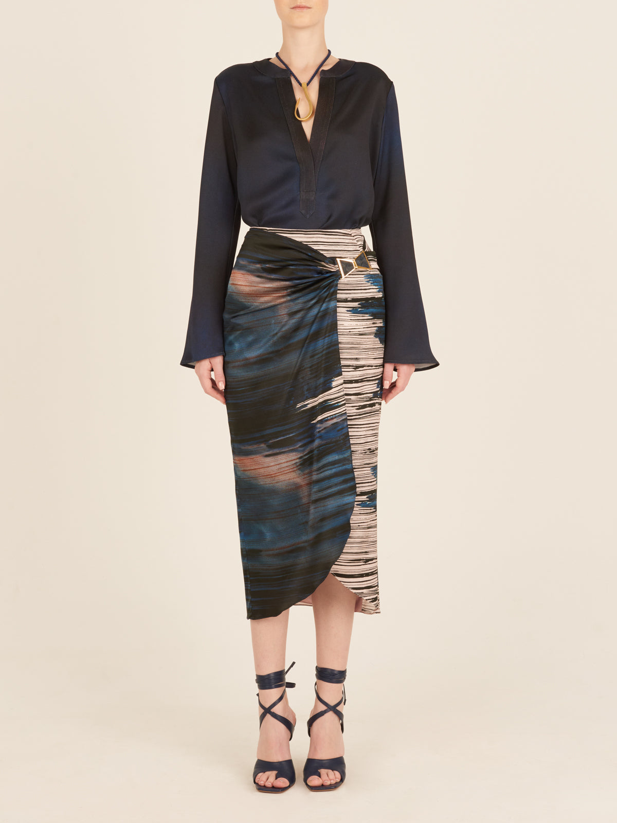 A lightweight Adrianne Skirt Indigo Linear midi skirt with a belt.