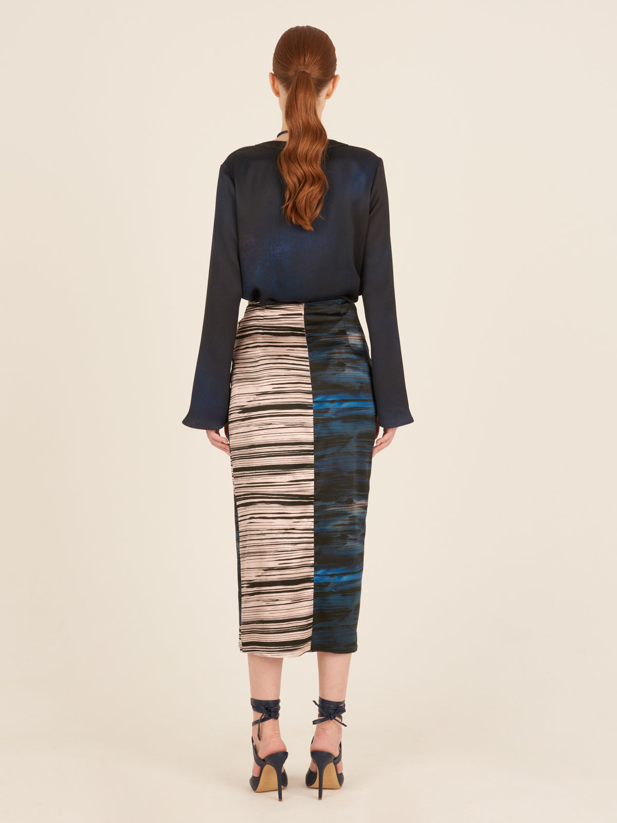 A lightweight Adrianne Skirt Indigo Linear midi skirt with a belt.