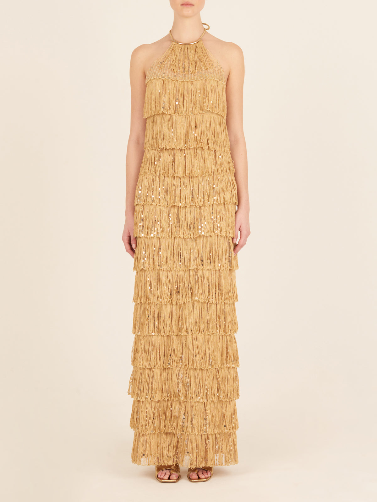 Oriana Dress Gold with tiered gold fringe detailing, displayed on a white background.