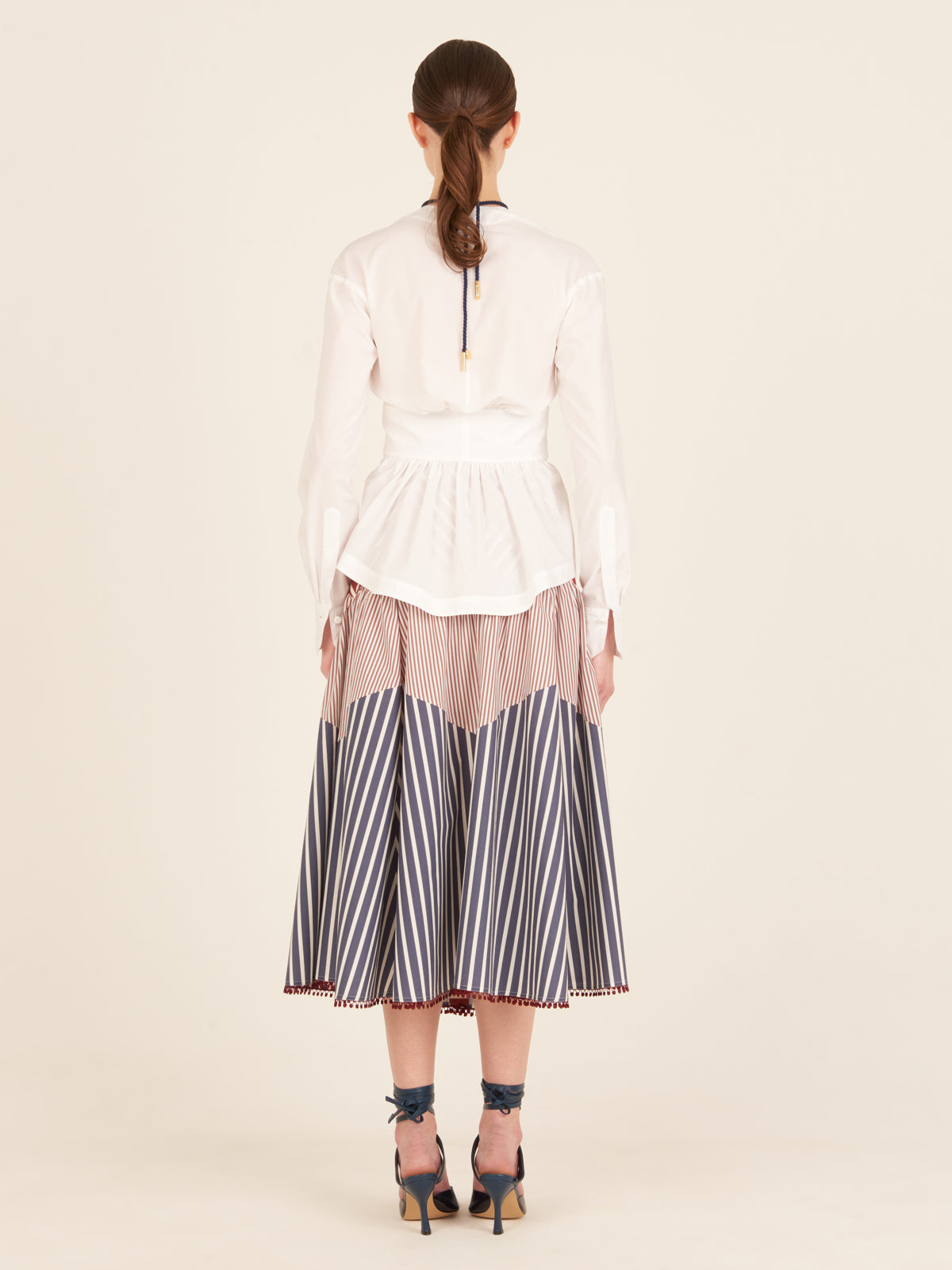 A Saanvi Blouse White with a v-shaped neckline and a bow at the neck.