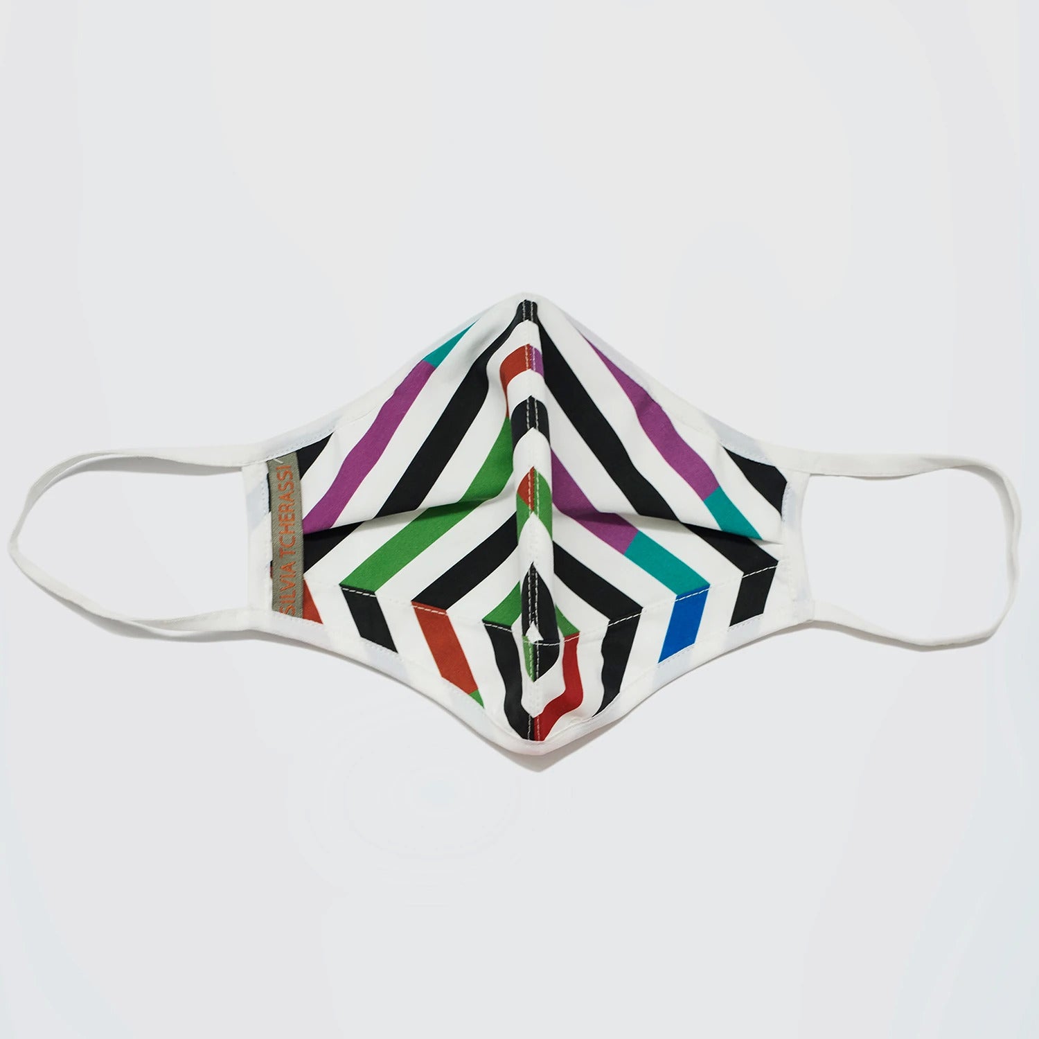 A face mask with a geometric pattern featuring diagonal black stripes and colorful chevrons in red, purple, green, and blue on a white background.