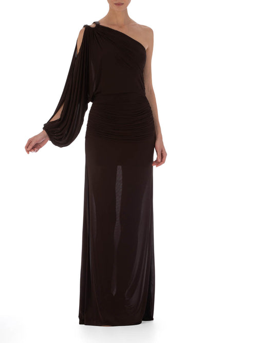 Woman in a Farah Dress Brown, a one-shoulder evening gown with leather ring detailing, posing in a studio setting.