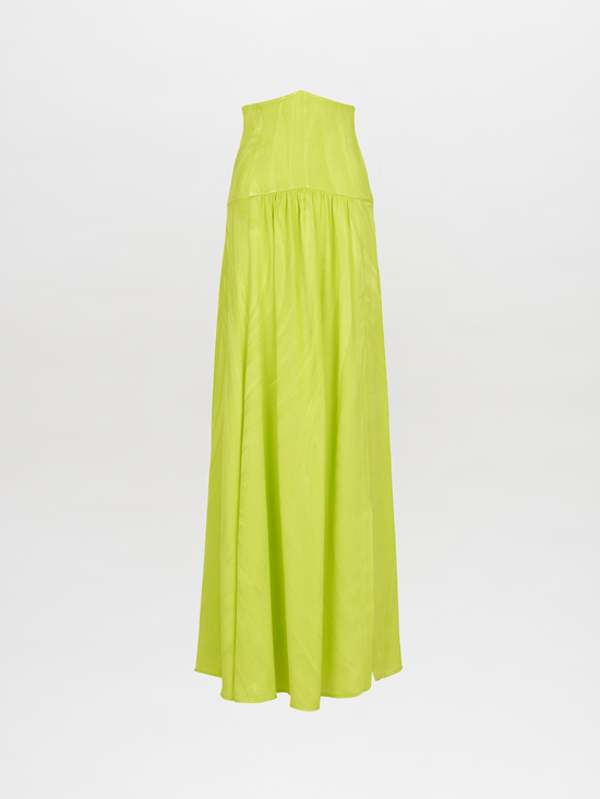 A person wearing the Febe Skirt Verde Lime, which features a cut-out design and an avant-garde, elegantly flowing skirt, making it a statement piece.