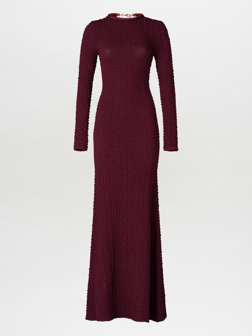 The model is wearing a pre-order Gabbice Dress Burgundy, set to ship by August 15th.