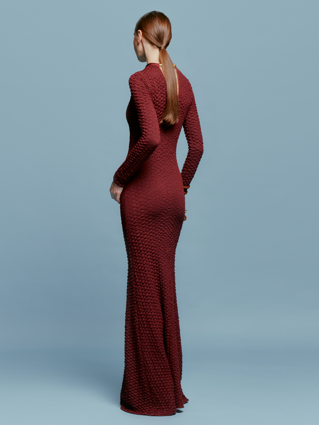 The model is wearing a pre-order Gabbice Dress Burgundy, set to ship by August 15th.