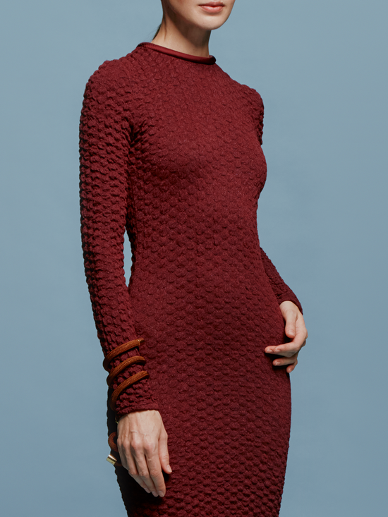 The model is wearing a pre-order Gabbice Dress Burgundy, set to ship by August 15th.