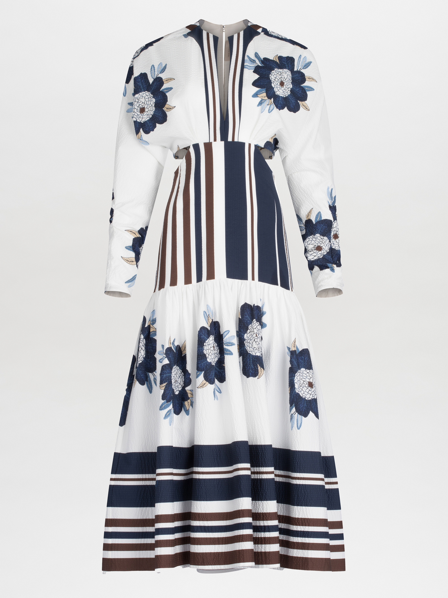 A long-sleeved Gabina Dress Multi Navy Brown Floral featuring a white base with blue floral patterns and horizontal navy stripes, designed with a flared skirt, isolated on a white background.