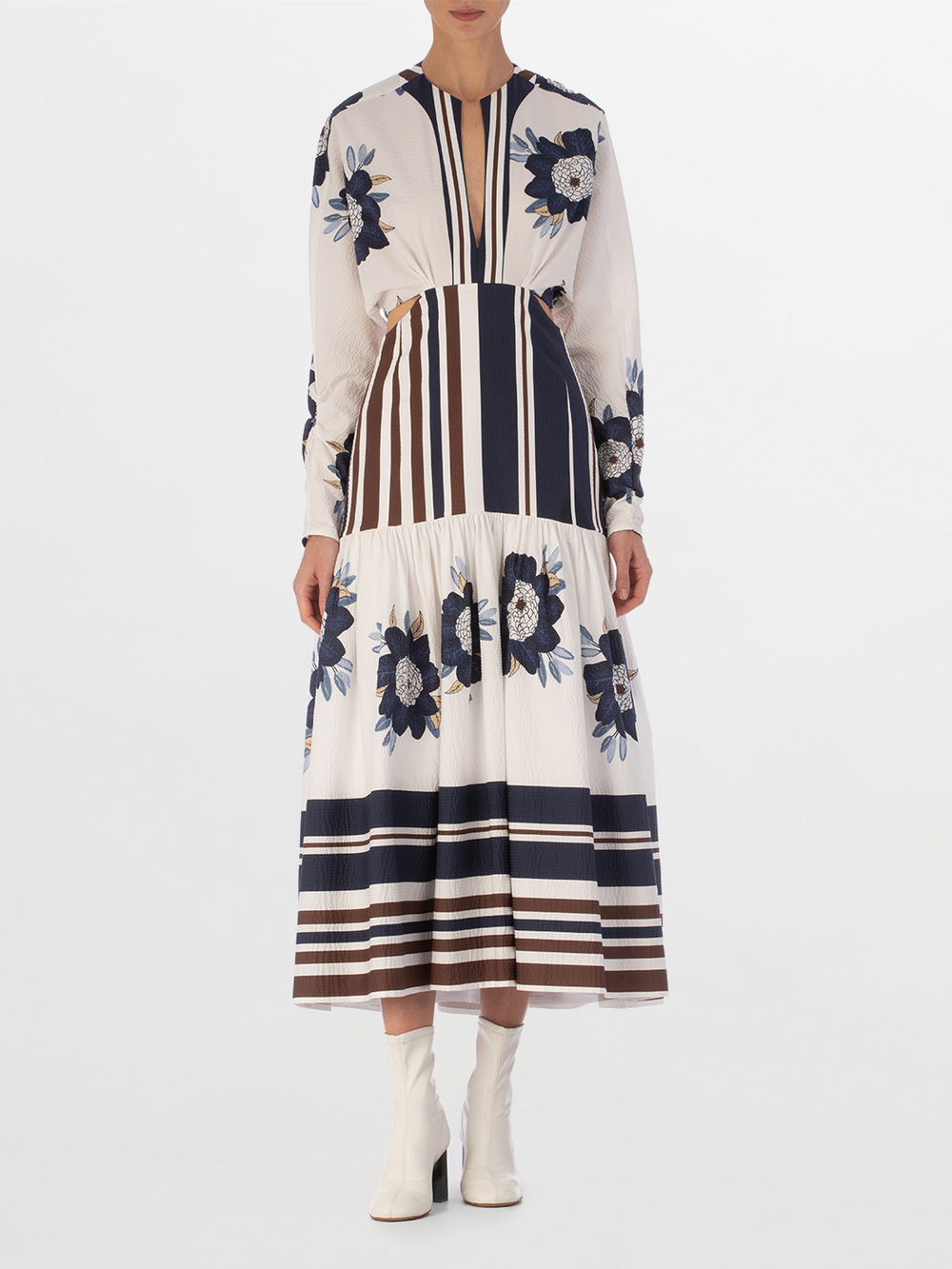 A long-sleeved Gabina Dress Multi Navy Brown Floral featuring a white base with blue floral patterns and horizontal navy stripes, designed with a flared skirt, isolated on a white background.